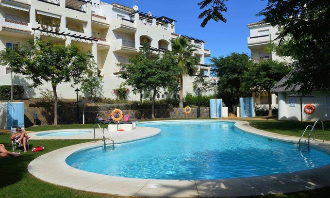 Manilva Apartment | Sabinillas Retreat: Terrace, Shared Pool & Private Parking