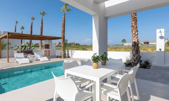 Petaloudes Villa | Discover Salty Sun Villa: Poolside Bliss with Ocean Views