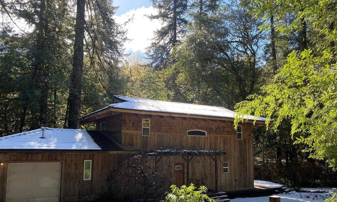 Coos Bay House | Serene Creekfront Lodge style home hidden away in Elliot National Forest