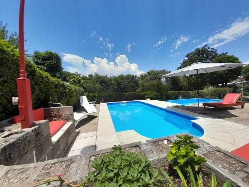 Villa Carlos Paz House | Relax at Sierras Del Sol with Oceanfront Views and Pool