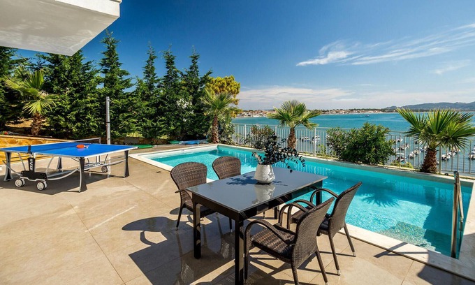 Agios Sostis House | Situated in an enviable beachside location, overlooking the picturesque fishing harbour of Agios Sos