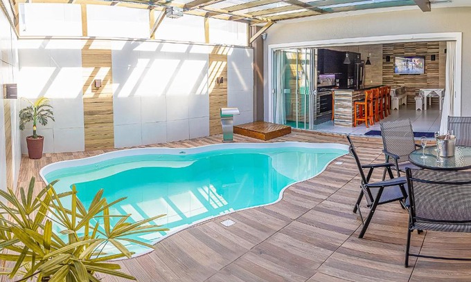 Enseada House | Inviting Retreat with Heated Pool Steps from the Beach