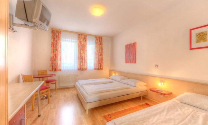 Rust Bed & Breakfast | Comfortable Triple Room with Pool at Hotel am See Rust