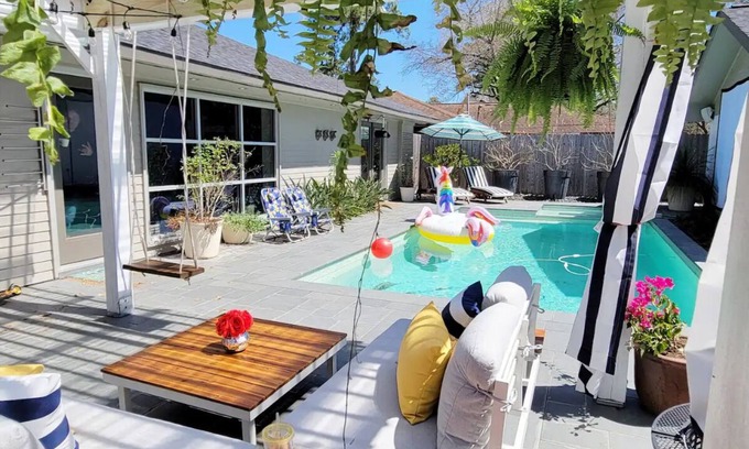 Greater Heights House | Relax in a Hot Tub by the Heated Pool and Ocean View