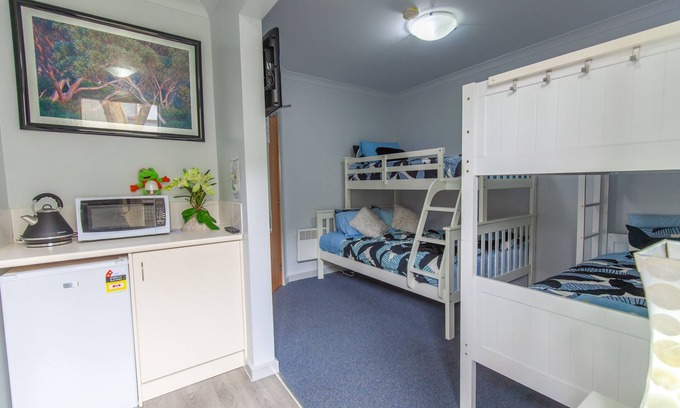 Baw Baw Village Cabin | Discover Tanjil Creek Lodge: Modern Bedroom with Kitchenette