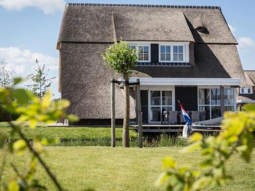 Delfstrahuizen Villa | Tranquil Thatched Villa by the Water with Family Amenities