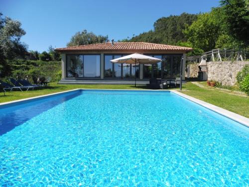 Portela House | Discover The Pool House: Oceanfront Retreat with Top Ratings