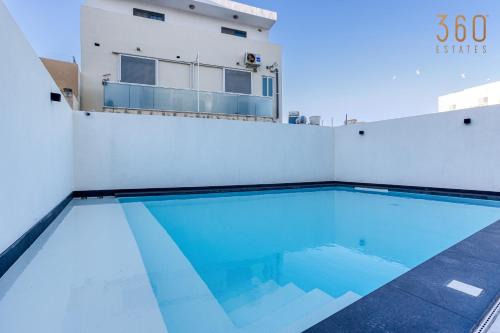 Swieqi Apartment | Relax at The Swieqi Poolside Suites with Family-Friendly Perks