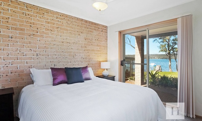 Gwandalan House | Waterfront Retreat: Steps from Shops, Clubs & Boat Ramp