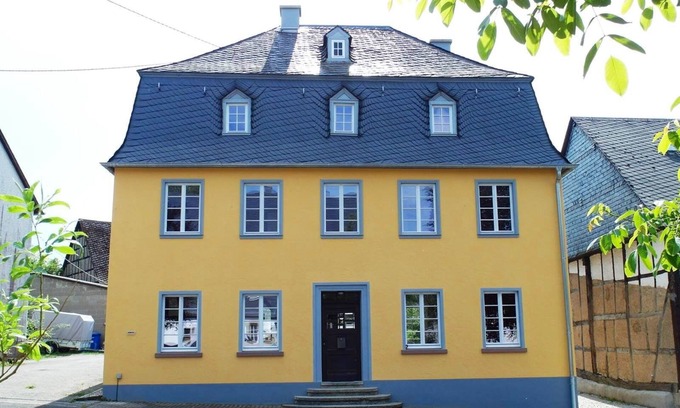 Irmenach House | Bright Yellow Vacation Home with Spa & Breakfast Included
