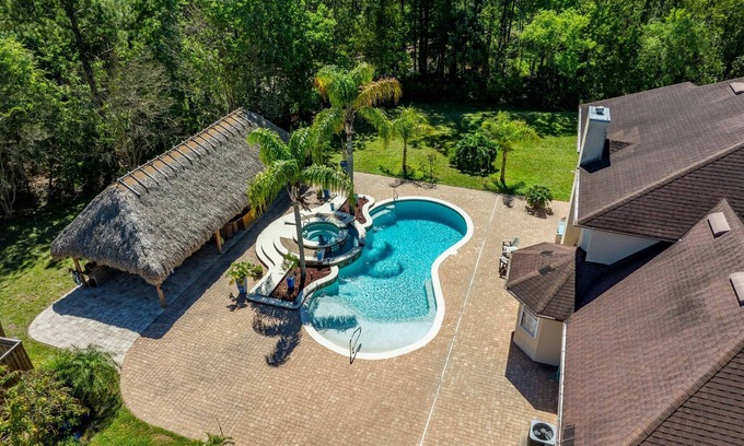 St. Augustine House | Relax at Tiki Bar with Heated Pool & Inviting Hot Tub
