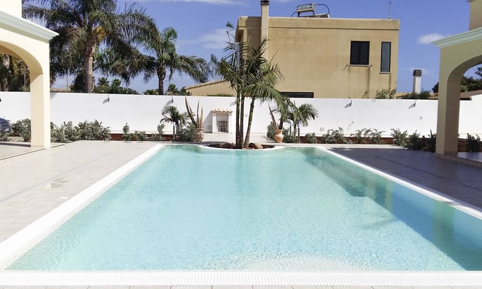 Mazara del Vallo Apartment | Relax at Tortuga3: Nighttime Pool and Oceanfront Views