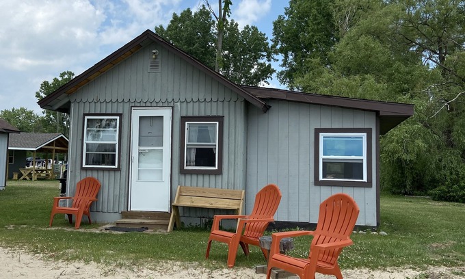 West Branch Cabin | Inviting Lakefront Cabin with Private Beach and Pool Access