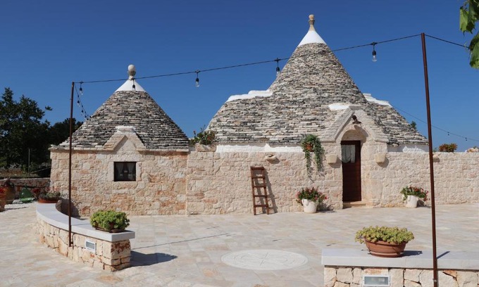 Putignano Apartment | Elegant Trullo Famiglia with Ocean View & Spa Amenities