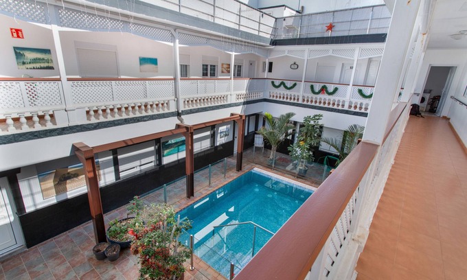 Playa de Arinaga Apartment | Vacation 'Casa Paula - 12' with Mountain View, Shared Pool and Wi-Fi