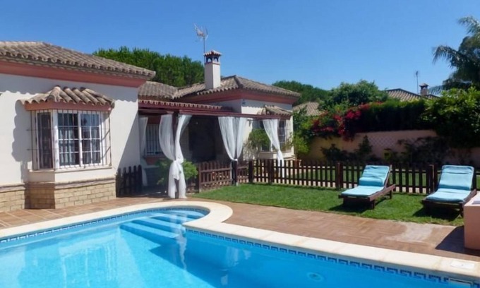 Chiclana de la Frontera Villa | Beautiful Villa Steps from the Beach with Pool & Ocean View