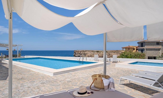 Cala en Forcat Apartment | Oceanfront VORAMAR: 4-Star Getaway with Pool & Hot Tub