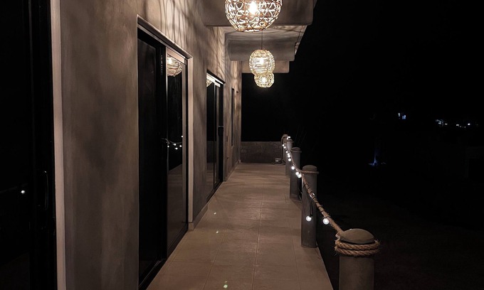 Troncones Bed & Breakfast | Warm room with the sea in the background and starry skies.