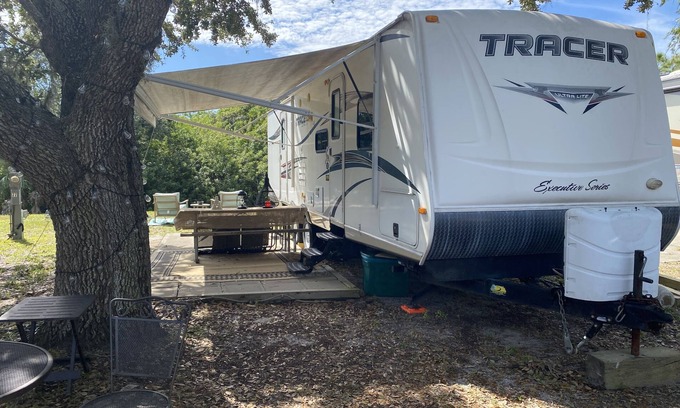 Riverwood RV Rental | Water Front Tracer RV: Pet-Friendly Getaway with Pool