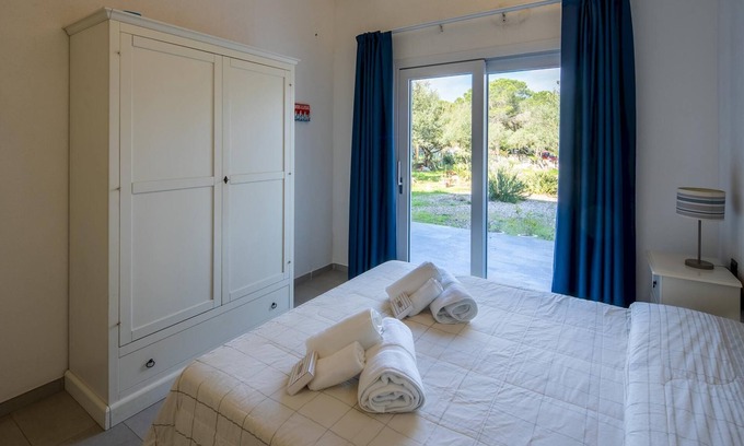 Cala Liberotto Apartment | Seafront Comfort at Welcomely - Porto Corallo Getaway