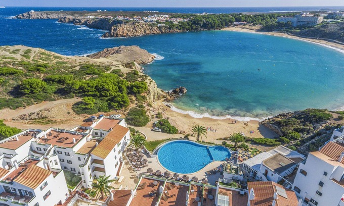 Arenal d'en Castell Apartment | Experience White Sands Beach Club: Top-Rated Oceanfront Escape