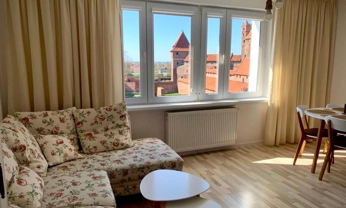 Malbork Apartment | Morning Views of the Castle with Family-Friendly Comfort