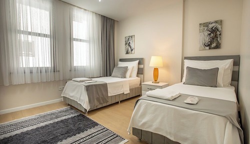 Executive Serviced Apartments with One King and Two Single Beds and a Private Balcony