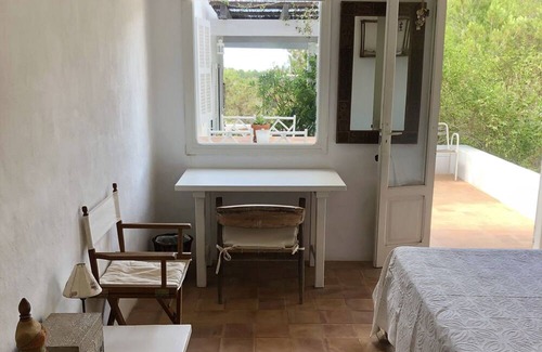 Es Cap de Barbaria House | Formentera. Room immersed in the woods with sea view.