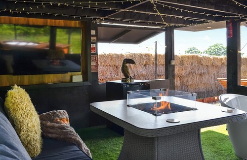 Storwood Cottage | Delightful Outdoor Area with Bath and Fire Pit Awaits You