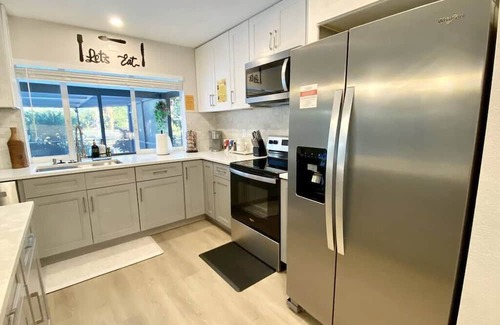 Biggar House | Gulf Gateway: Poolside Fun with Dock and Grill Access