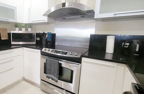 Bahamia West Condo | Gated Lux family size condo near beach w/boat dock, working station, pool, canal