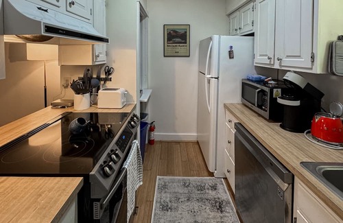Quechee Condo | Cozy condo w/balcony, river view, electric woodstove, w/d, wifi, kitchen, a/c