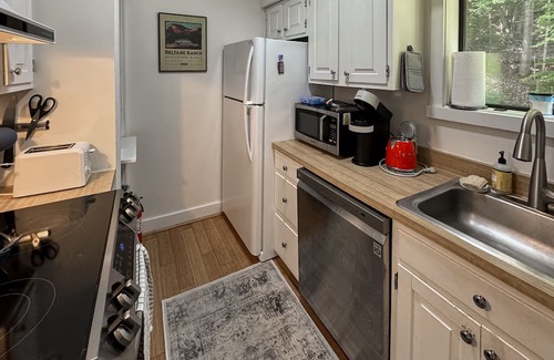 Quechee Condo | Cozy condo w/balcony, river view, electric woodstove, w/d, wifi, kitchen, a/c