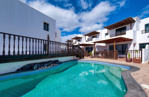 Punta Mujeres Ski Chalet | Casa Hibiscus - Shared Pool and BBQ - Close to Seafront Promenade By Lanzarote Vacation Homes