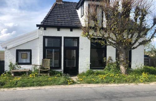 Sint Jacobiparochie Villa | Unique Dijkhuis with Elegant Interior for Family Getaways