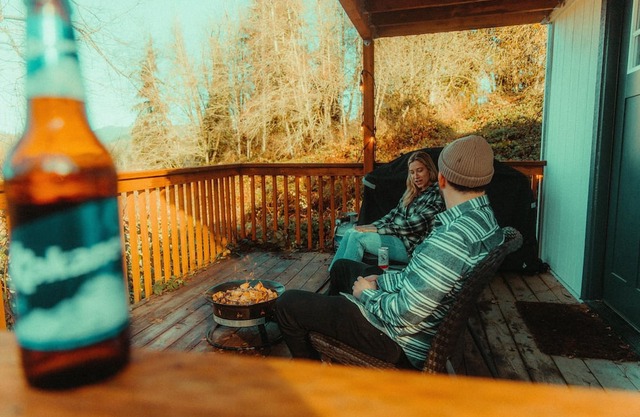 Modern PNW cabin surrounded in wooded forest with a private pond