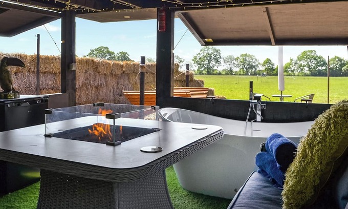 Storwood Cottage | Delightful Outdoor Area with Bath and Fire Pit Awaits You